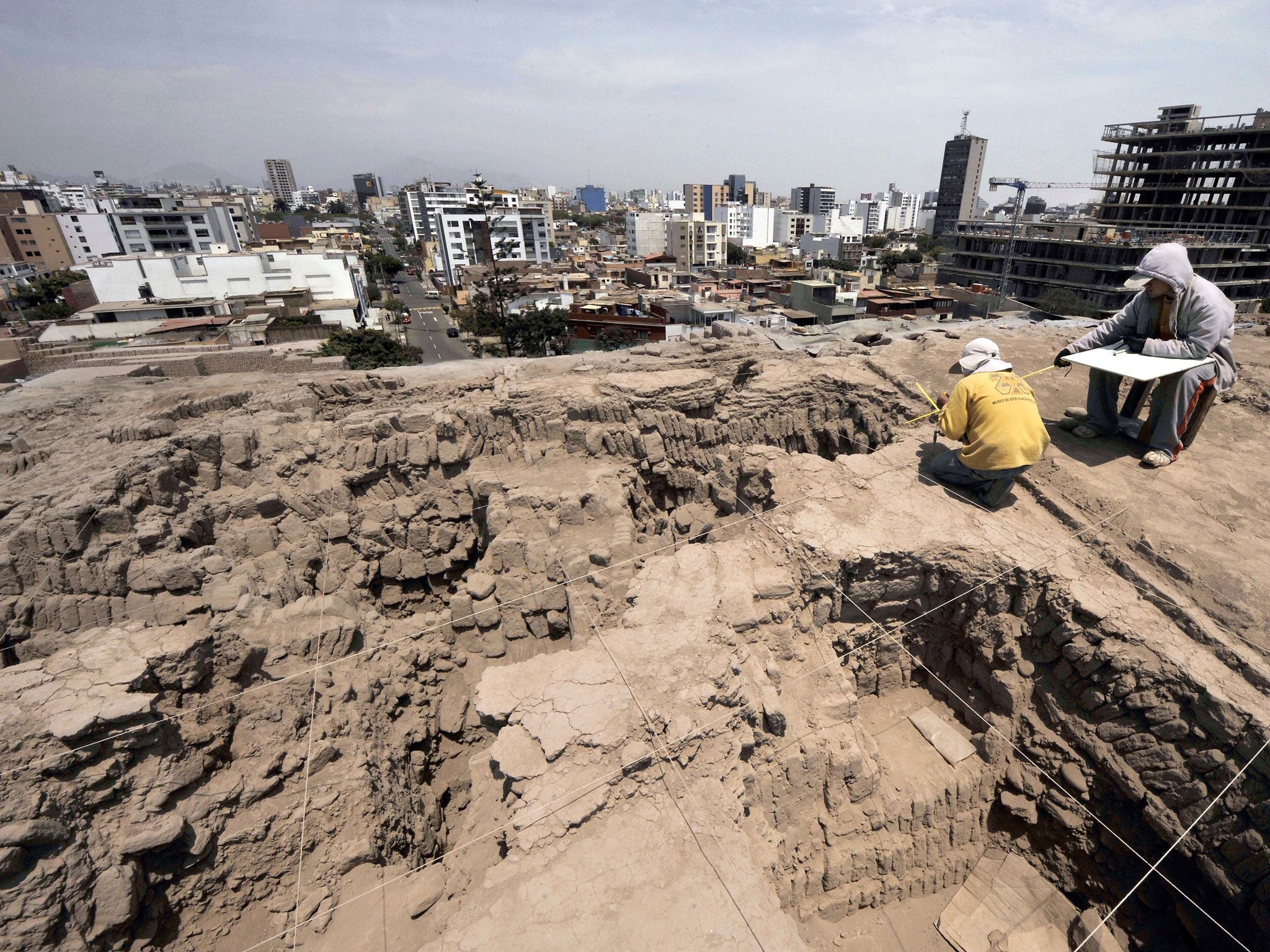 Archaeologists work at the pre-Inca religious complex 'Huaca Pucllana'