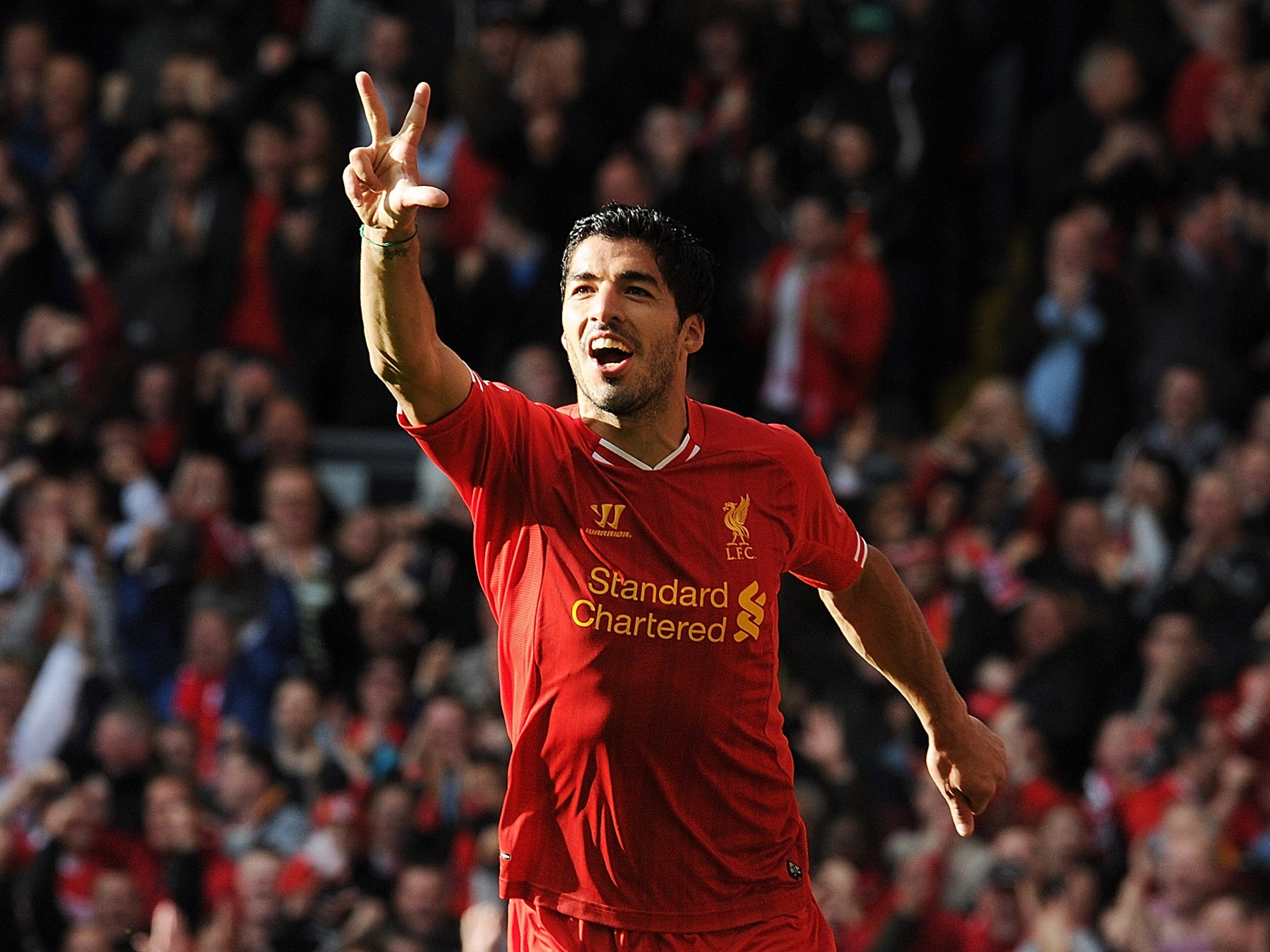 Luis Suarez celebrates his hat-trick for Liverpool against West Brom