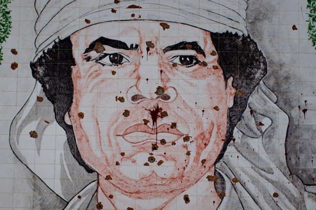 Scars of war: A bullet-riddled Gaddafi mosaic in Tripoli