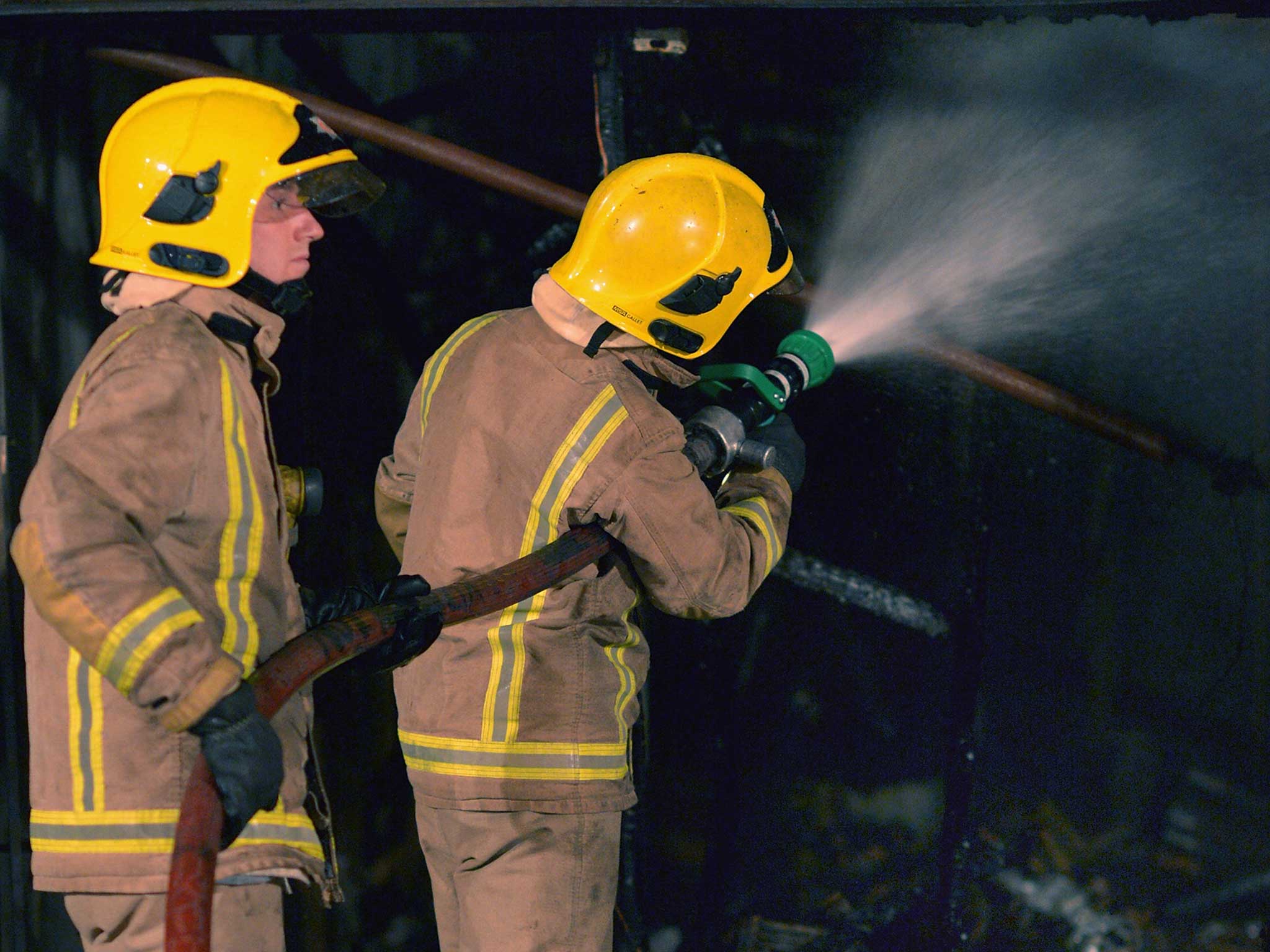 A fire crew attend a fire last year; Fire chiefs have warned the Home Office of the fire risk present in an immigration centre from damage five years ago