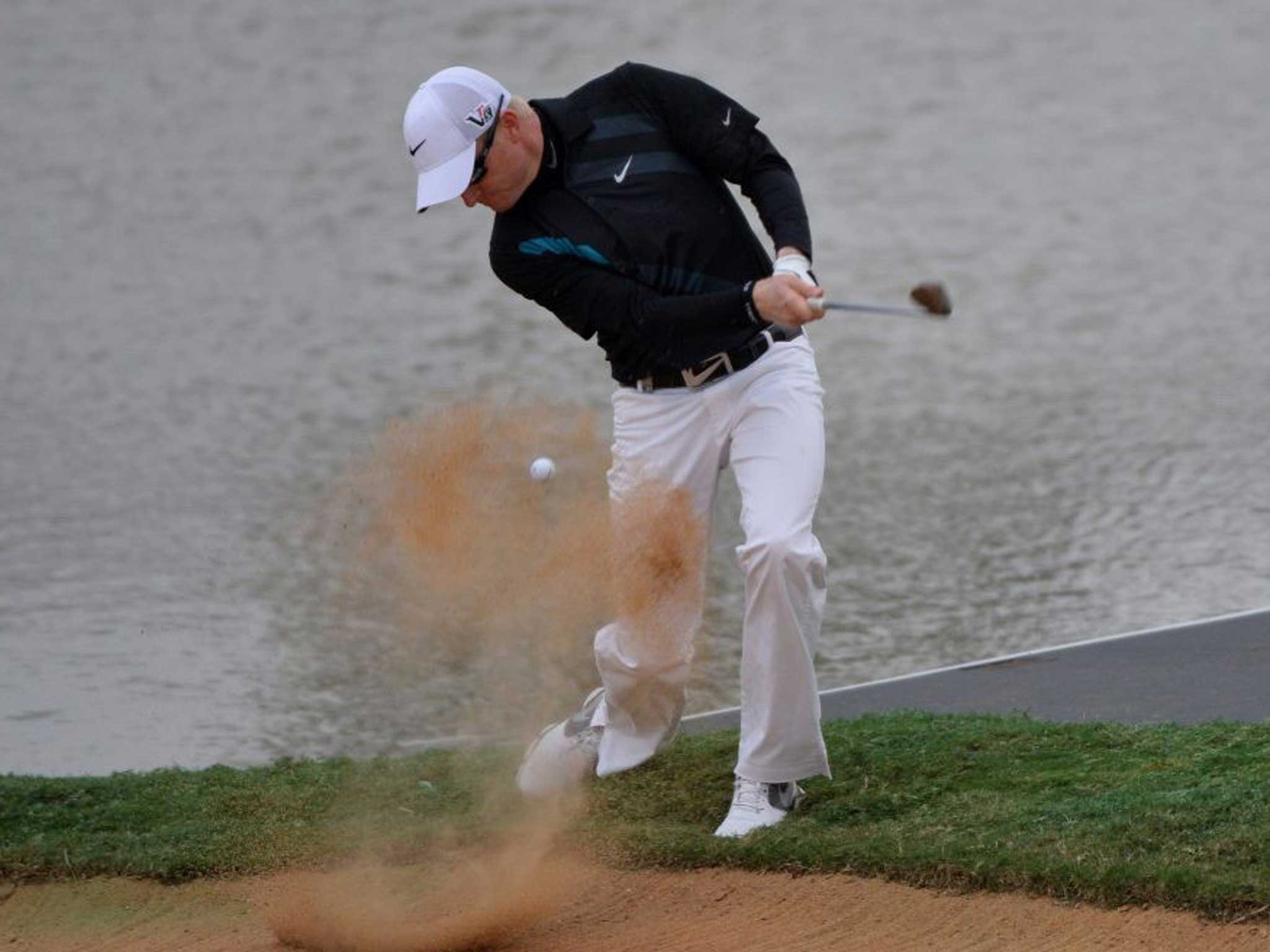 Sand bar: Simon Dyson plays out of a bunker before his disqualification
