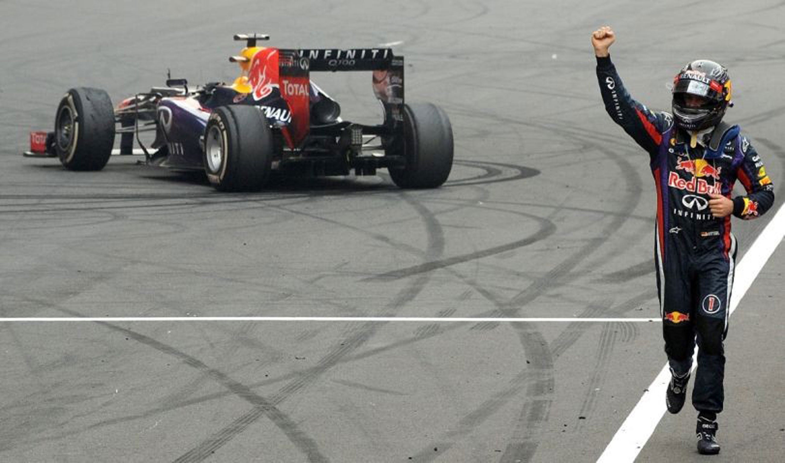 Red Bull driver Sebastian Vettel of Germany celebrates after winning the Formula One Indian Grand Prix 2013