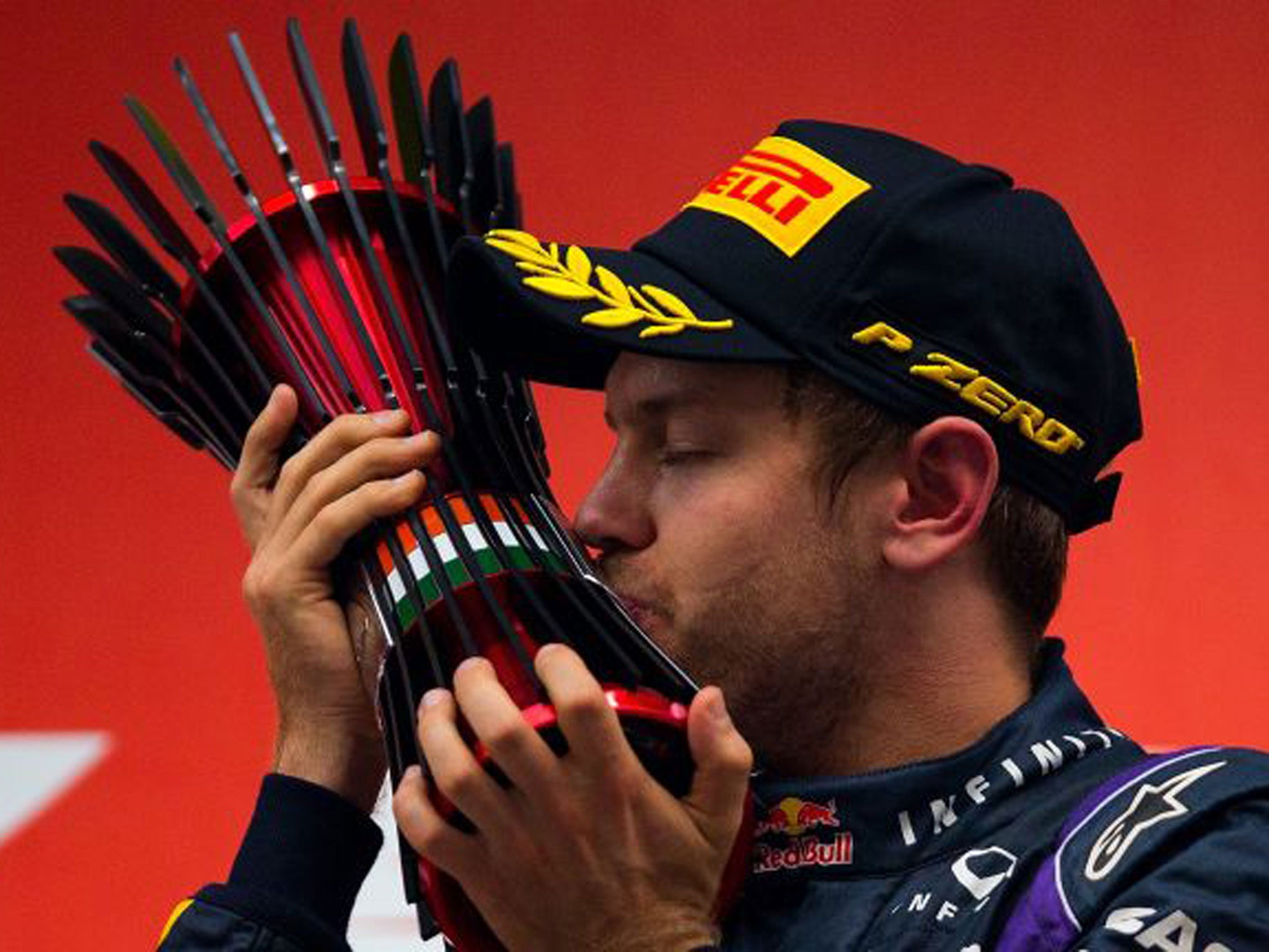 Sebastian Vettel of Germany celebrates on the podium after winning the Indian Grand Prix