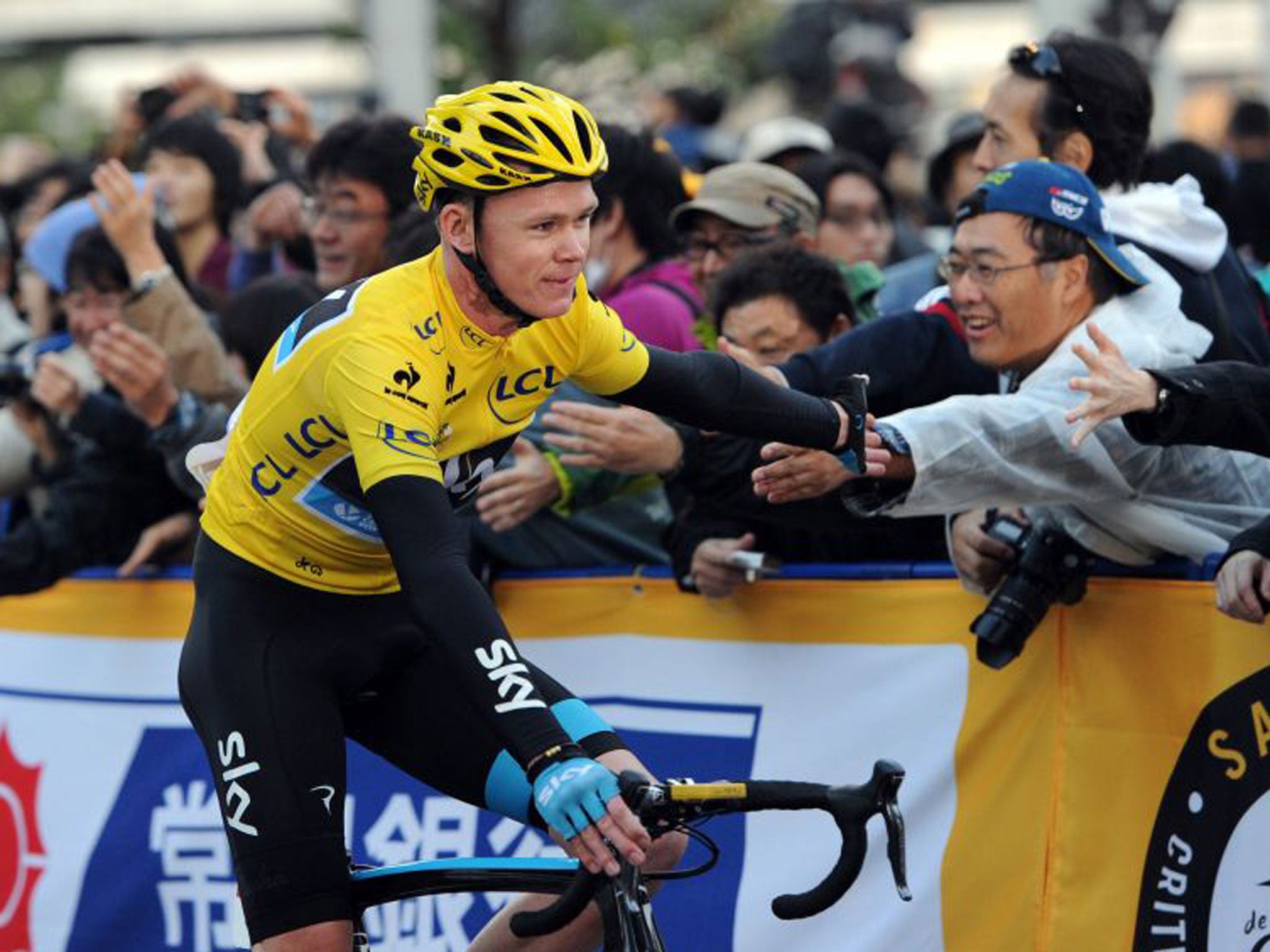 Chris Froome greets the fans after winning in Saitama
