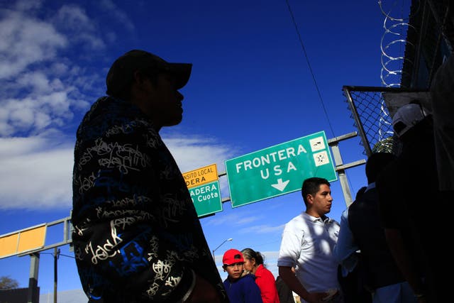 Deportees wait outside an aid centre for returned migrants in Nogales, Mexico