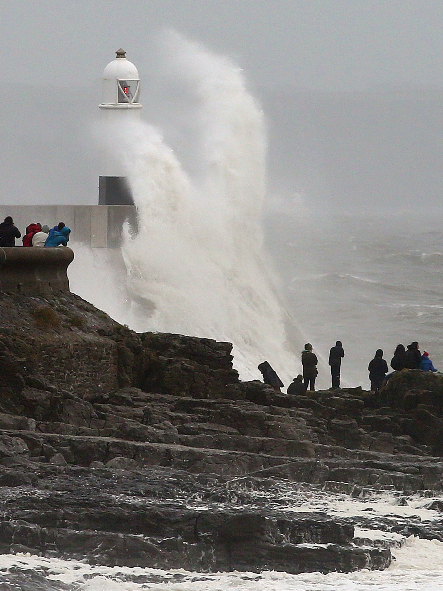 Waves crash against the sea barriers in Porthcawl, south Wales