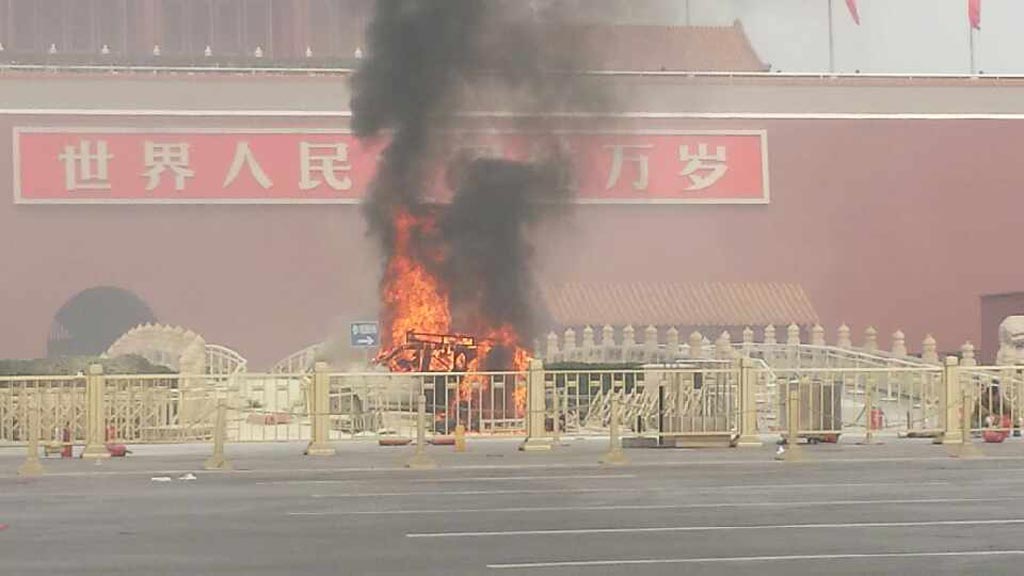 A vehicle burns in Tiananmen Square, China
