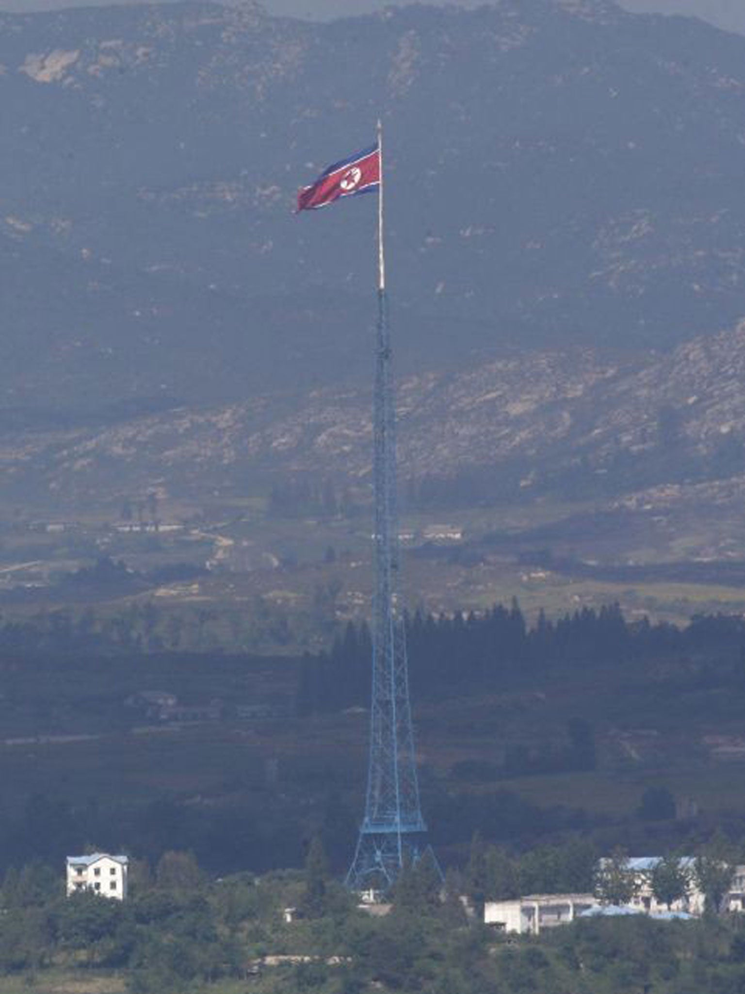 A giant North Korean flag flies near the border village of Panmunjom. Six South Koreans have crossed the Demilitarized Zone from the North. The men returned home from detention on Friday to questions about how they ended up in the North and why Pyongyang was freeing them