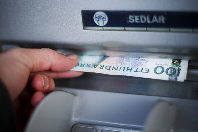 In the most cashless society on the planet, Swedish Crowns currency banknotes are withdrawn from an ATM machine in Stockholm
