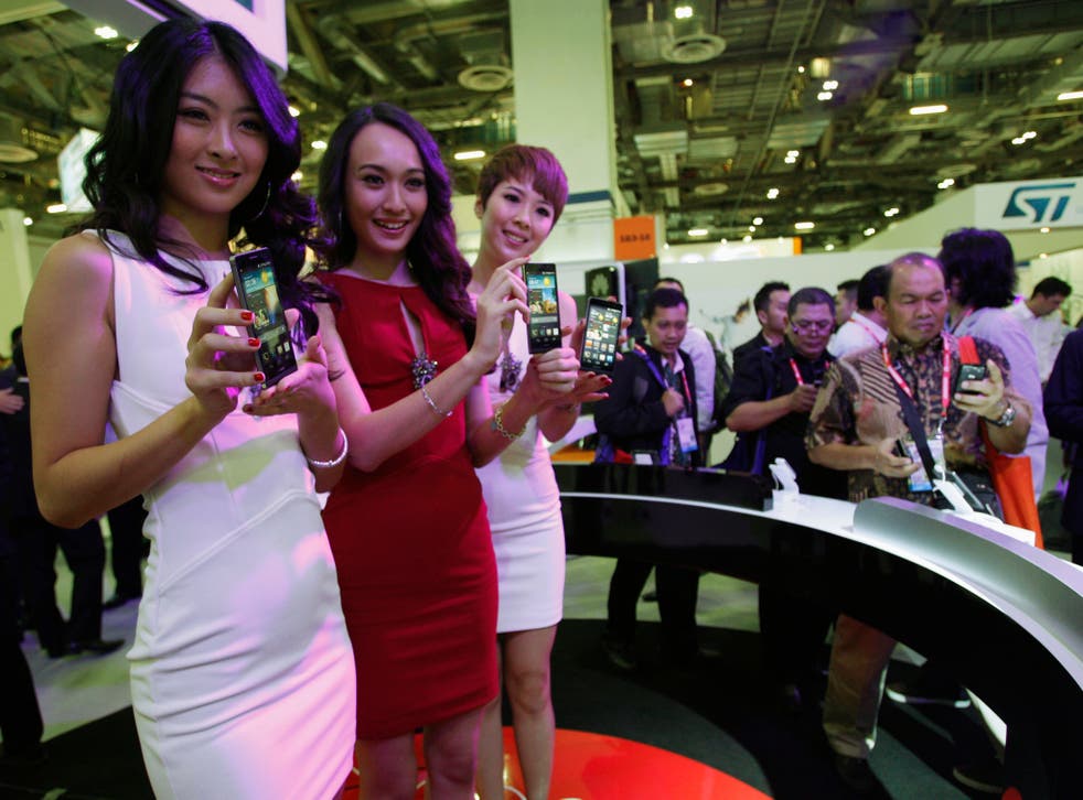 Models present the Huawei Ascend P6 smartphone at the CommunicAsia communication and information technology exhibition in Singapore June 19, 2013. 