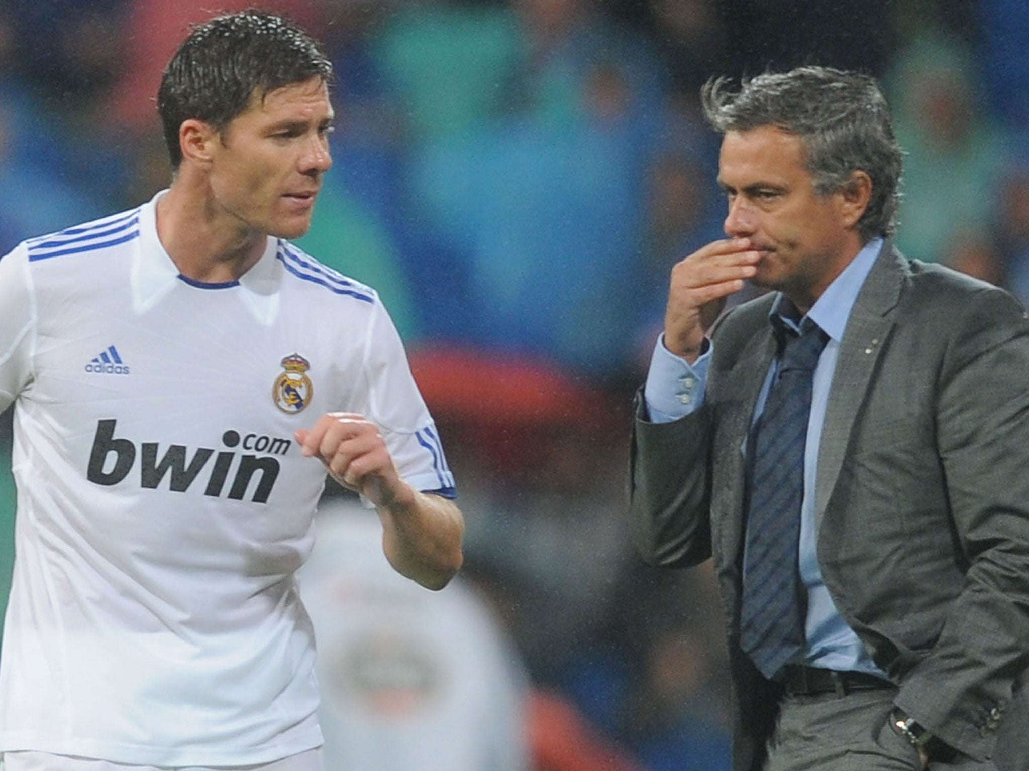 Xabi Alonso (left) speaks with manager Jose Mourinho during their time together at Real Madrid