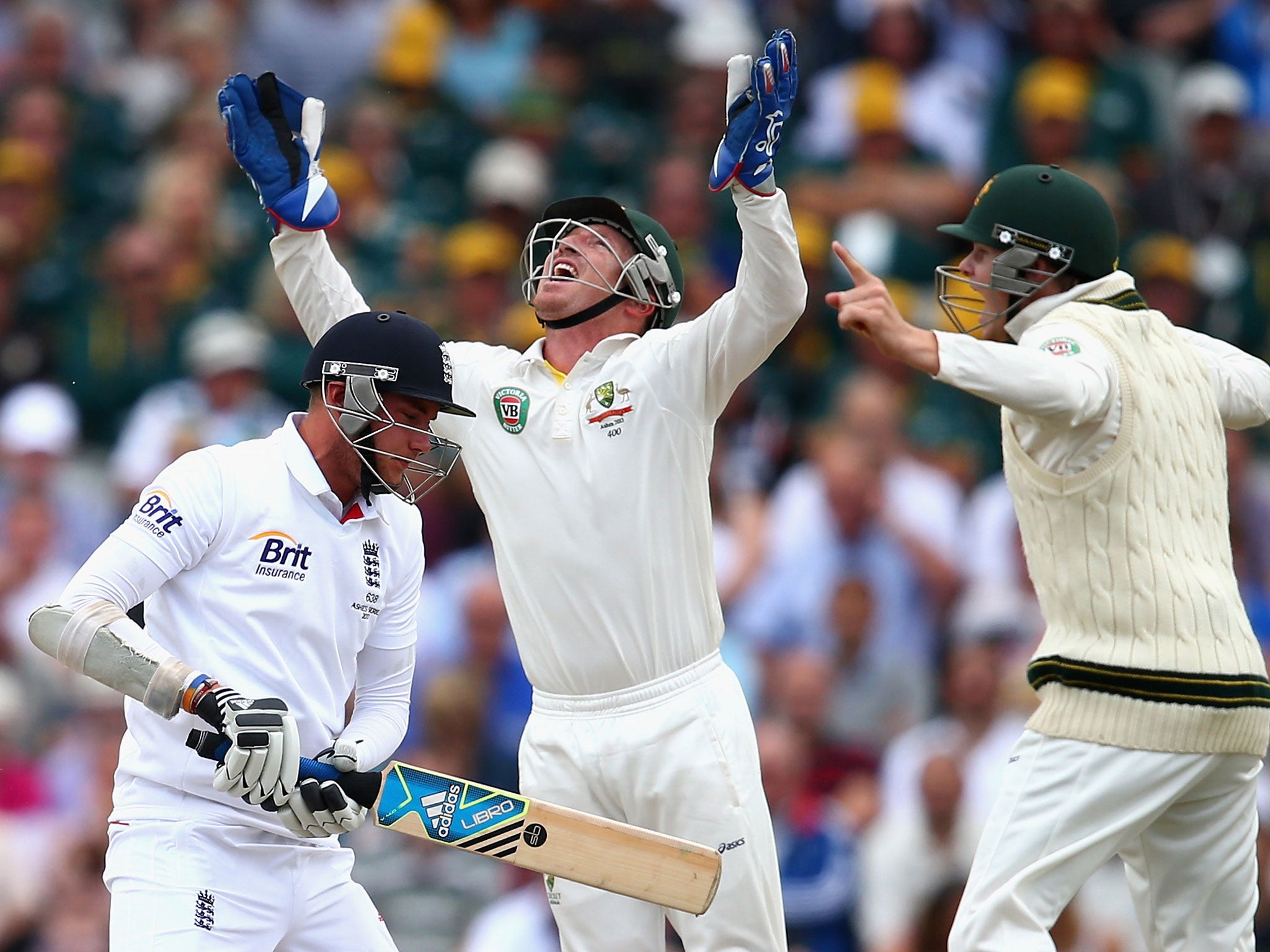 Brad Haddin (centre) catches Stuart Broad (left) off the bowling of Nathan Lyon during day four of the third Ashes Test between England and Australia at Old Trafford on 4 August