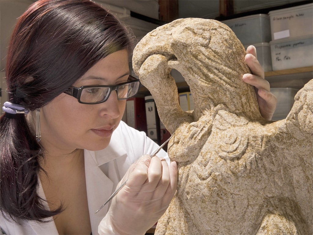 MOLA conservator Luisa Duarte working on the eagle sculpture