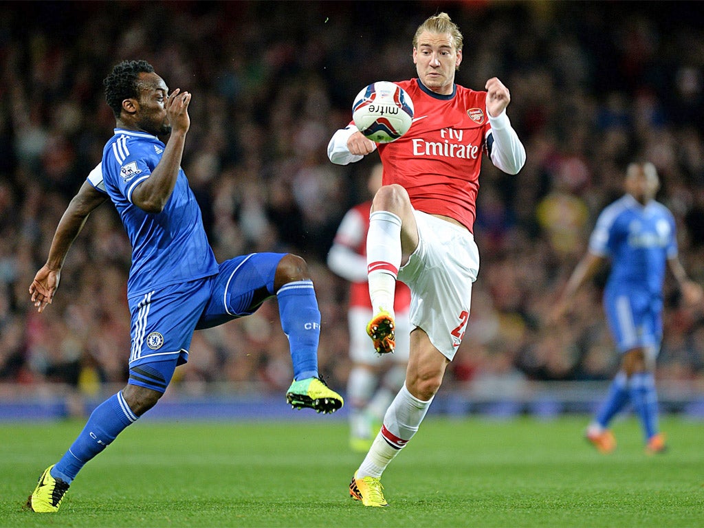 Michael Essien tackles Nicklas Bendtner, who was poor for Arsenal