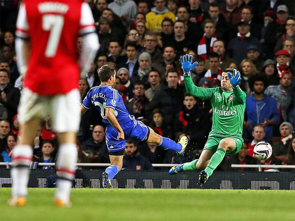 Cesar Azpilicueta toes the ball past Lukasz Fabianski