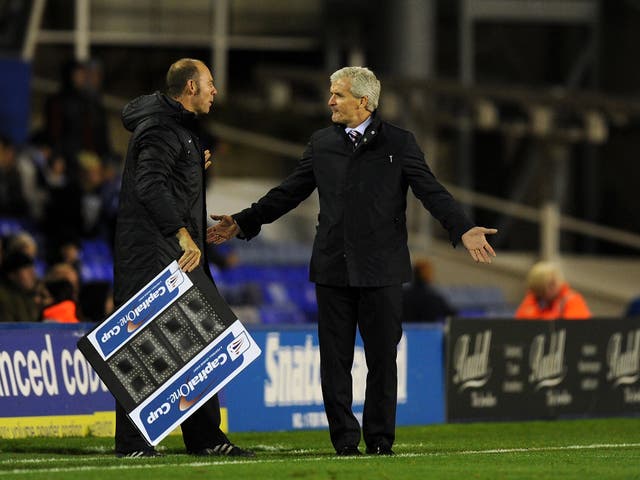 Stoke manager Mark Hughes complains to fourth official Andy Haynes after he showed five minutes of injury time