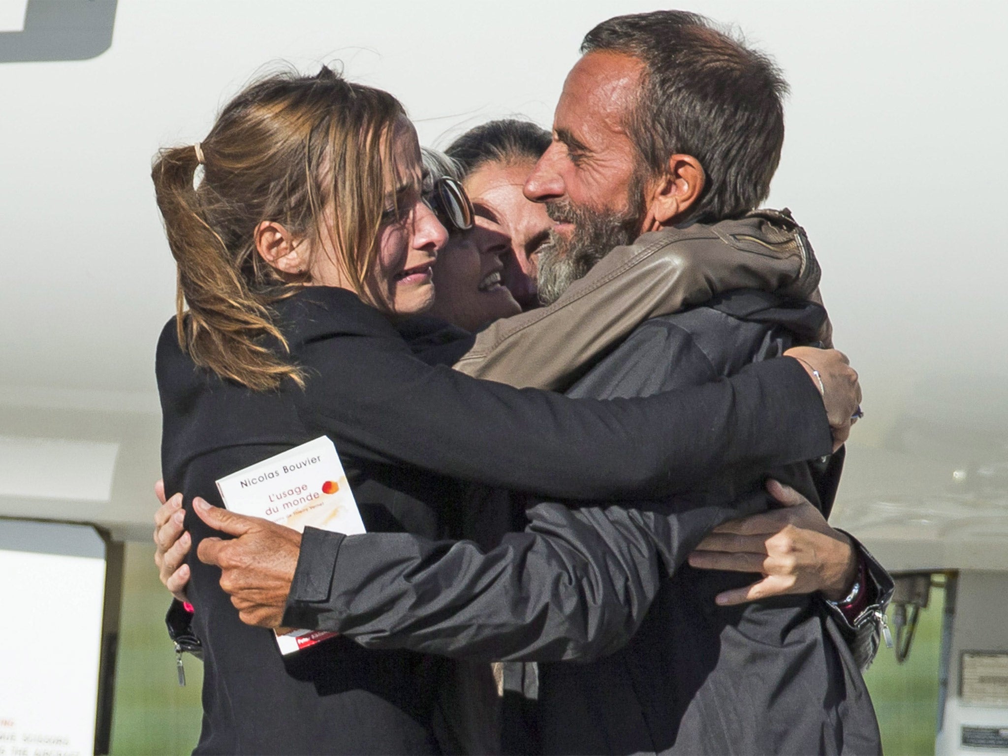 Family members greet the freed hostage Daniel Larribe as he arrives at a military airport near Paris