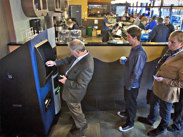 Customers queue to use the new ATM