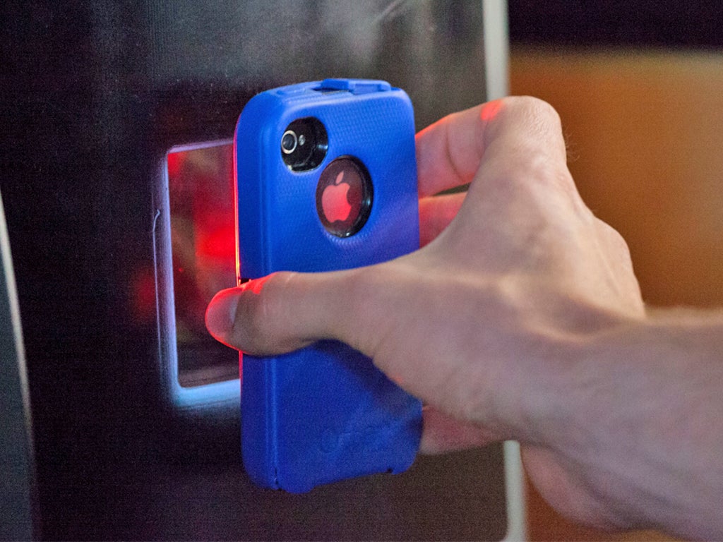 A user scans a QR code on their smart phone to transfer bitcoins (Getty)