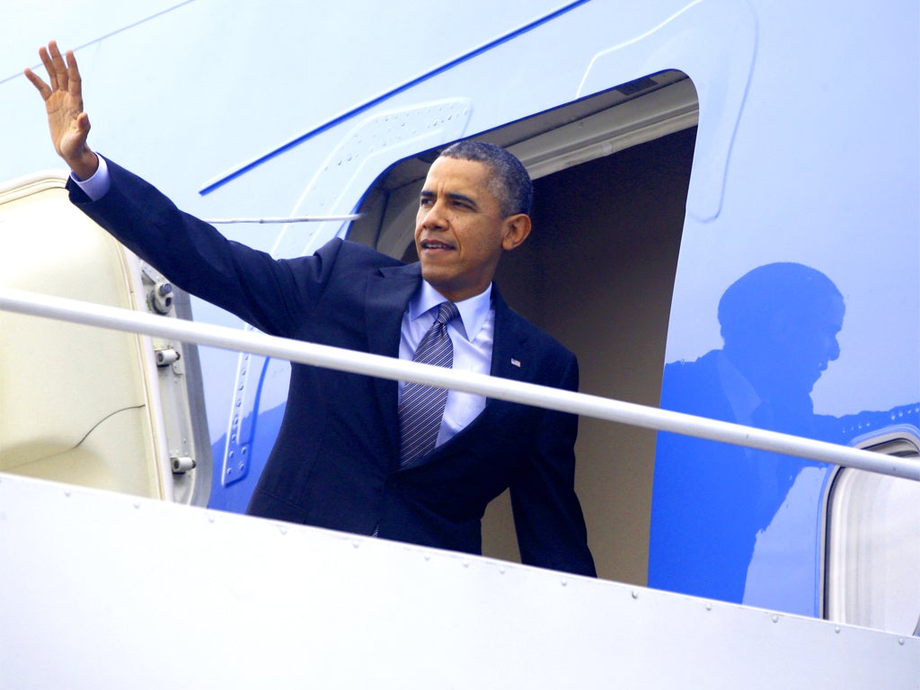 Reforms in jeopardy: Barack Obama waves as he boards Air Force One on his way to Boston