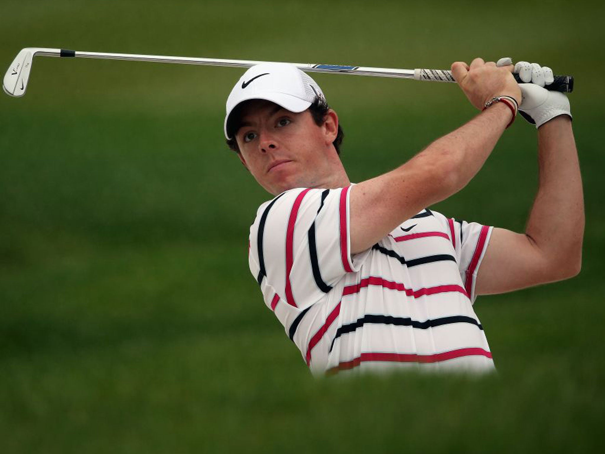 Rory McIlroy hits his second shot on the ninth hole during the first round in Shanghai
