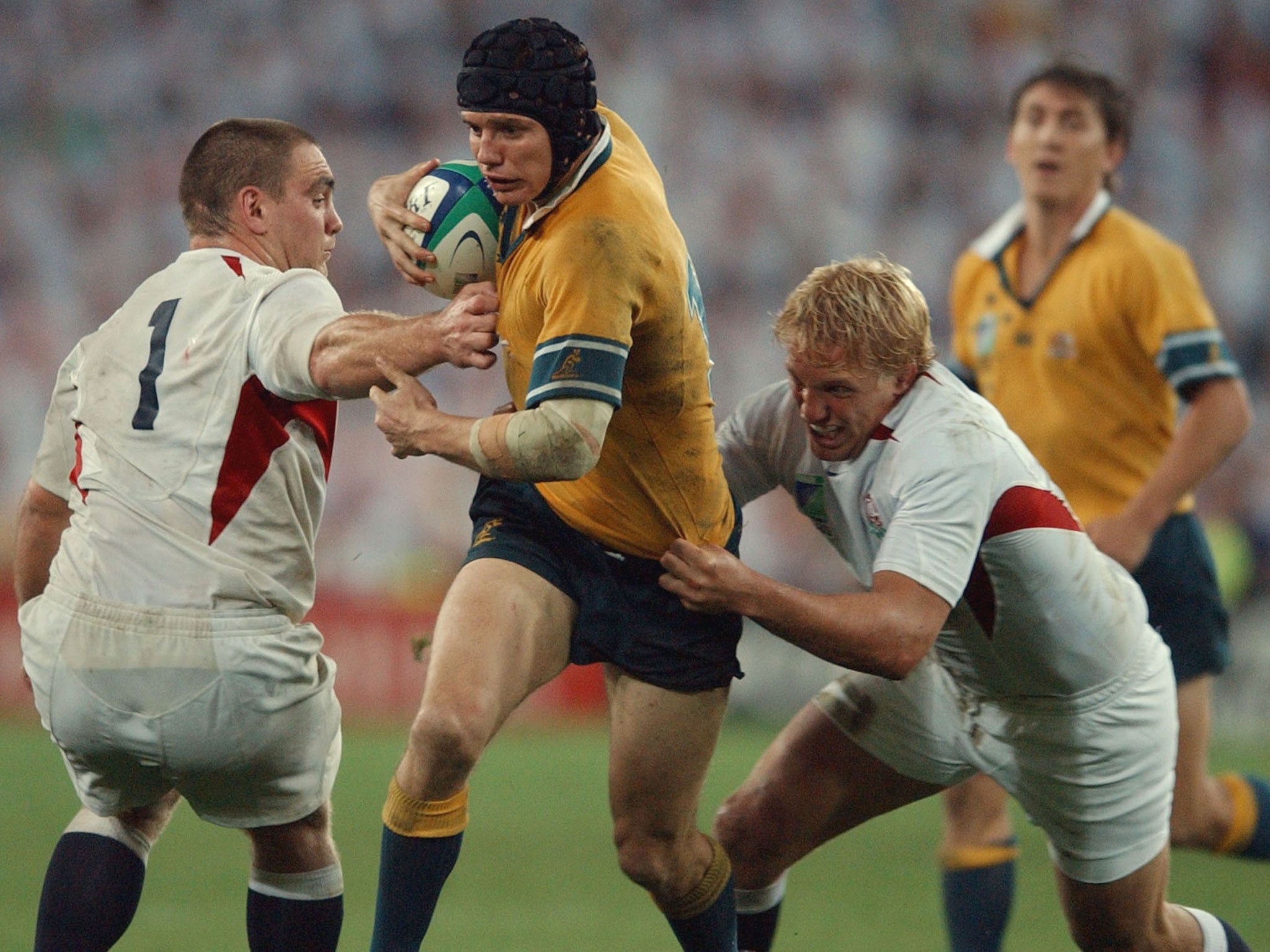 Lewis Moody (right) lines up a tackle on Australia's Stephen Larkham during the World Cup final in Sydney 10 years ago