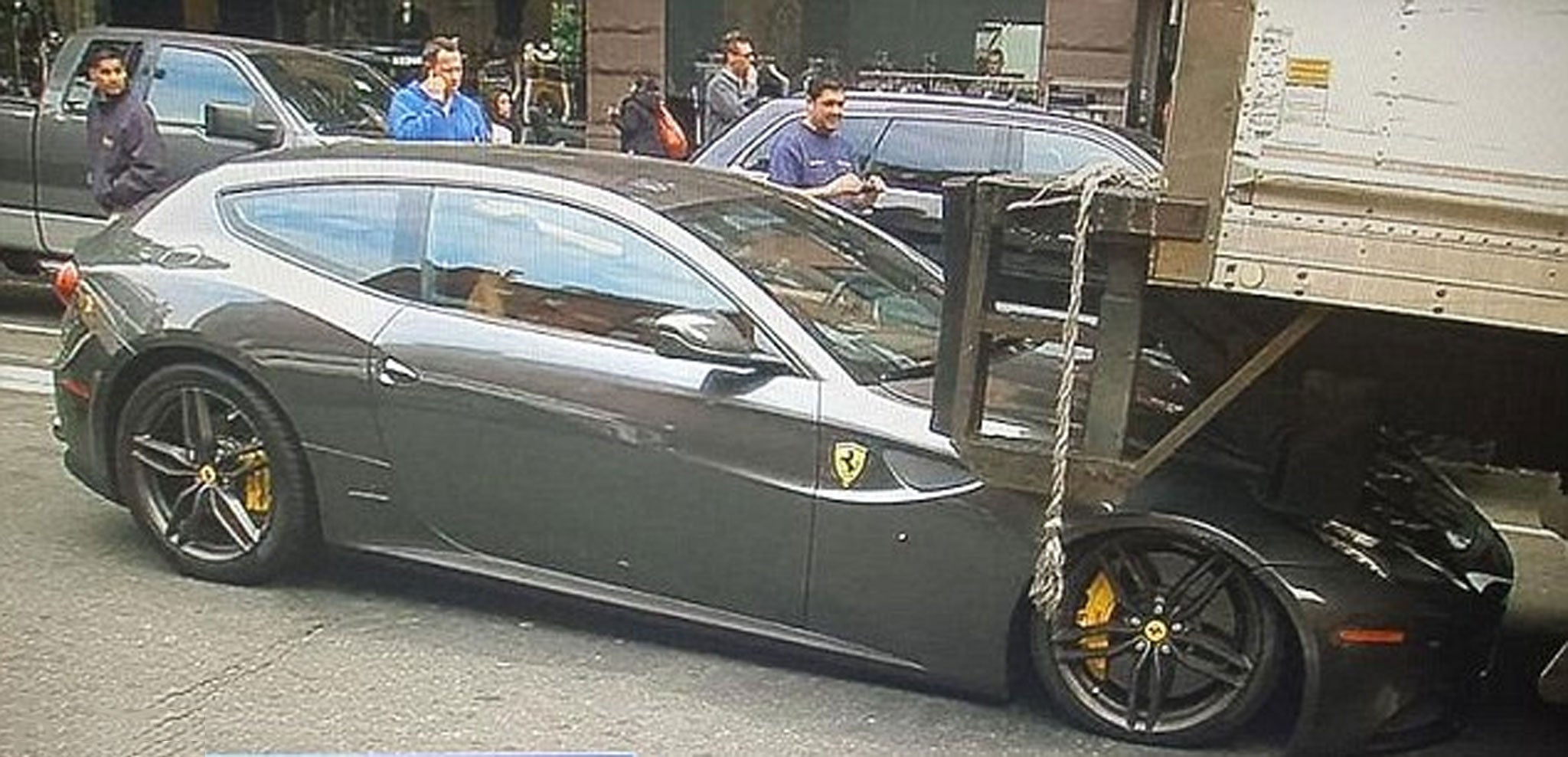 A brand new $300,000 Ferrari FF scraped and crushed beneath the weight of a delivery lorry