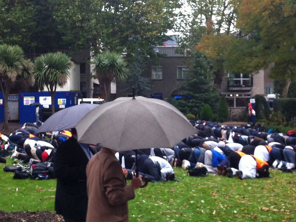 Muslims at Queen Mary University, London, praying in the rain