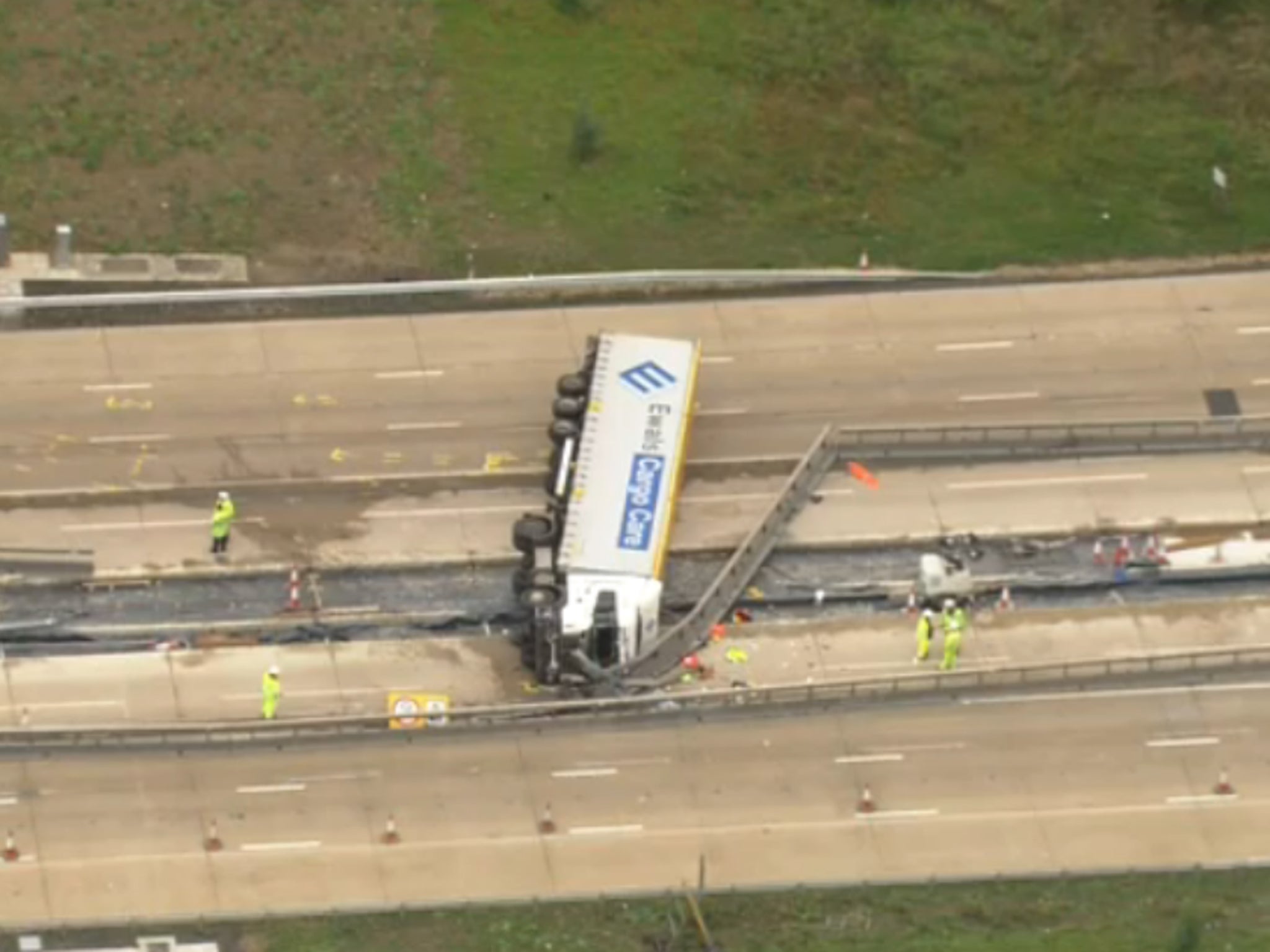 The lorry lies over the central reservation on the m25