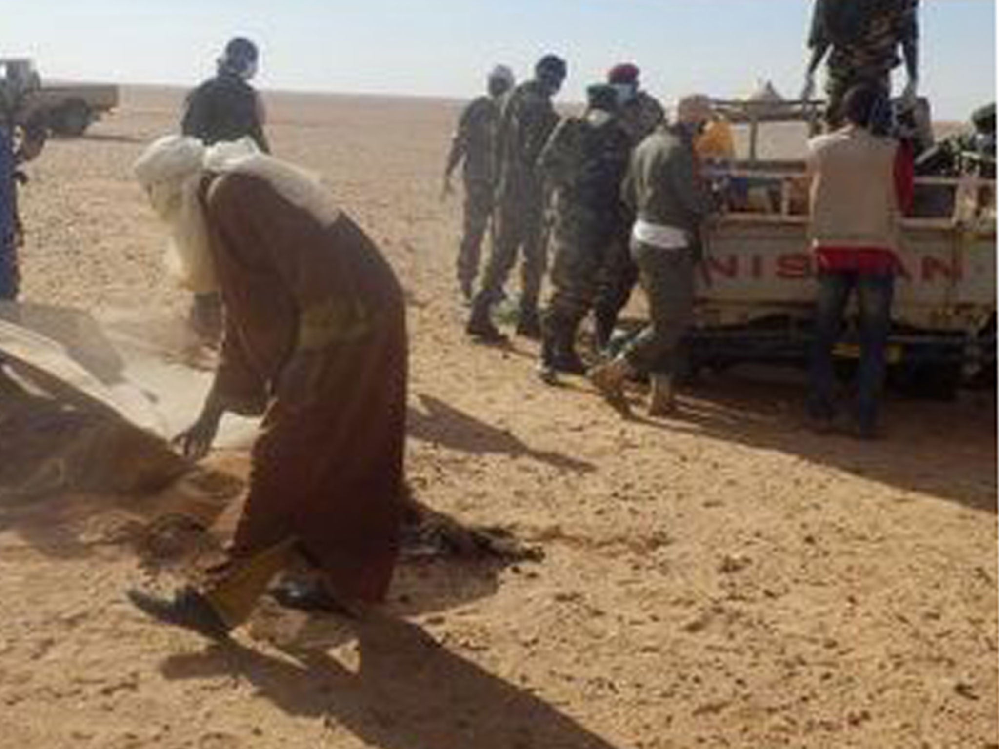 Rescue workers in the Sahara desert, where the bodies of 92 immigrants were discovered