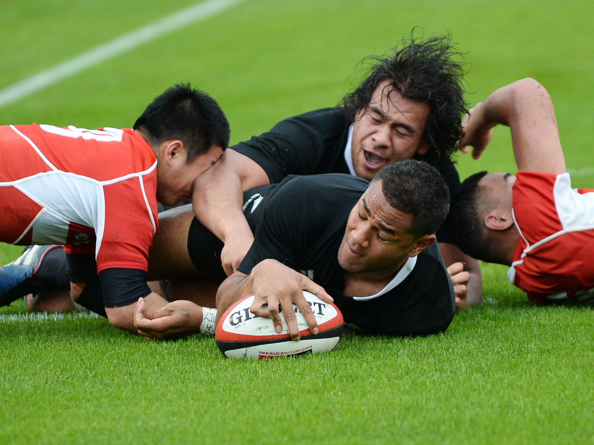 New Zealand's Frank Halai reaches out to score a try against Japan