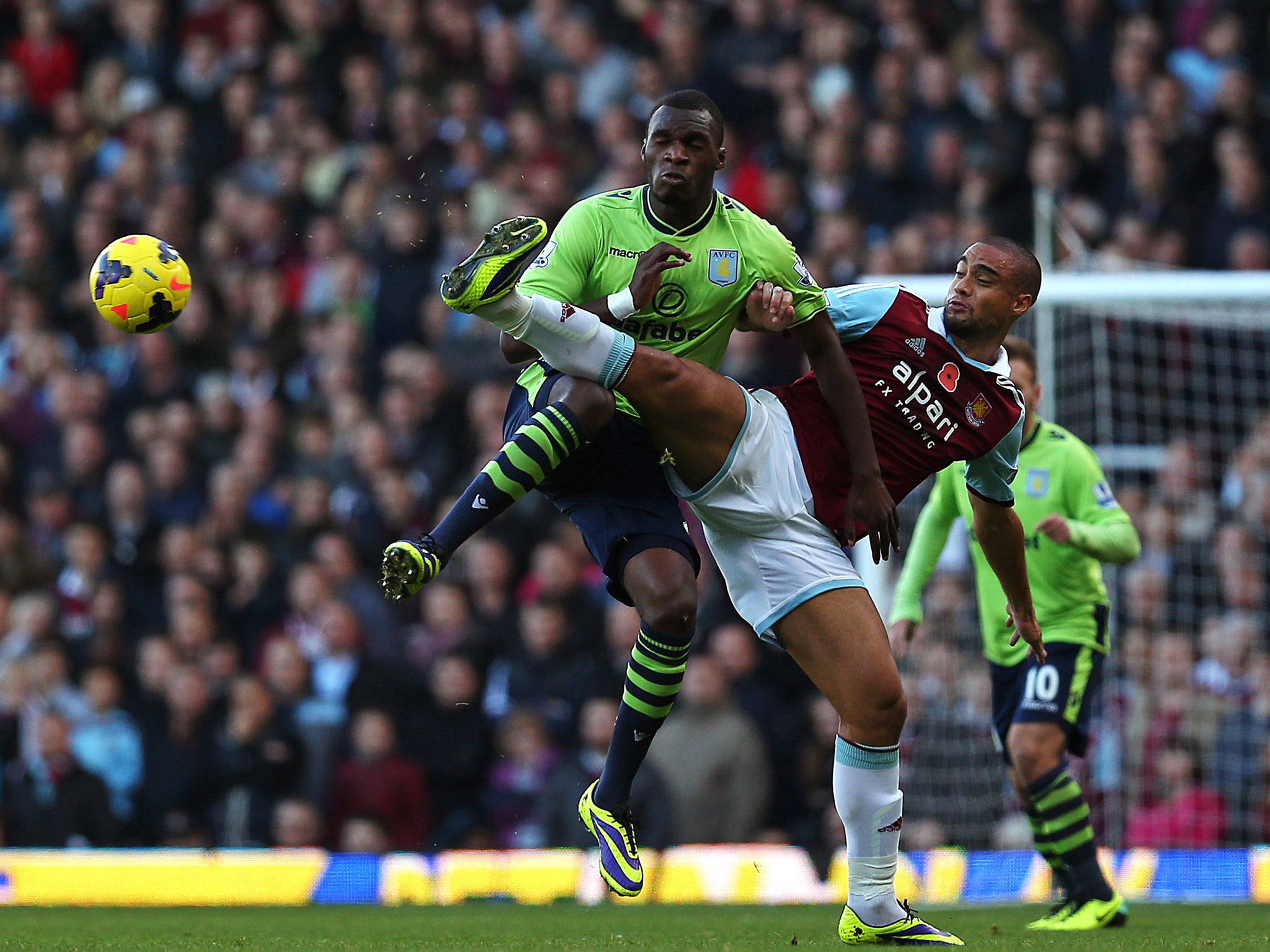 Christian Benteke challenges Winston Reid in West Ham's Premier League clash with Aston Villa