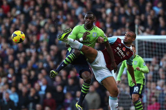 Christian Benteke challenges Winston Reid in West  Ham's Premier League clash with Aston Villa