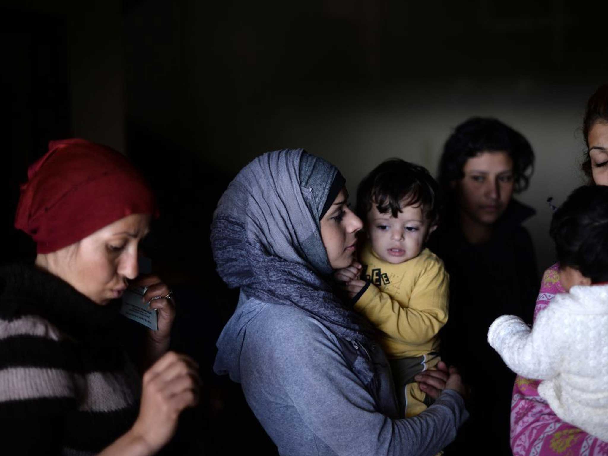Syrian women and children wait for medical attention at a Bulgarian shelter