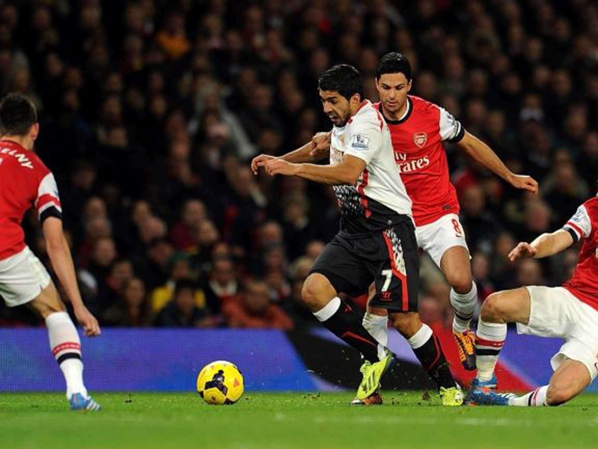 Target man: Luis Suarez of Liverpool tangles with Arsenal’s Mikel Arteta