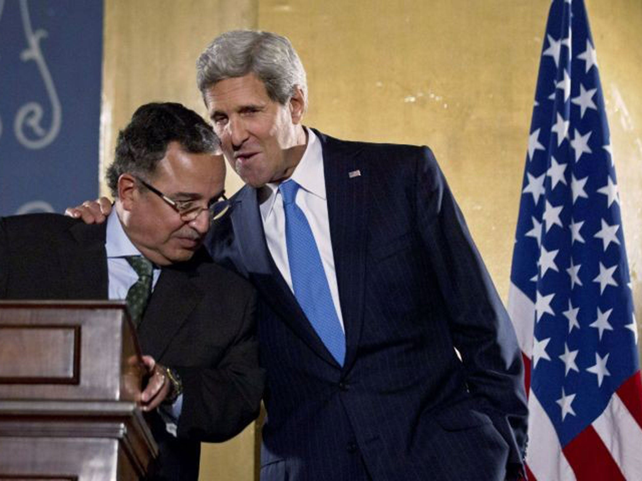 U.S. Secretary of State John Kerry, right, speaks with Egypt's Foreign Minister Nabil Fahmy during a joint press conference in Cairo