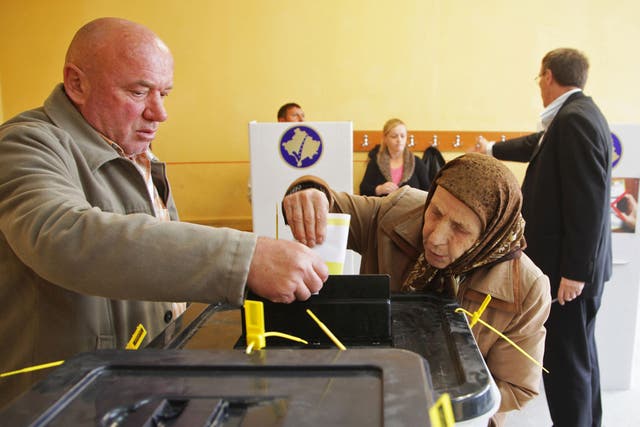 Ethnic Albanians cast their votes at the polling station in the town of Mitrovica