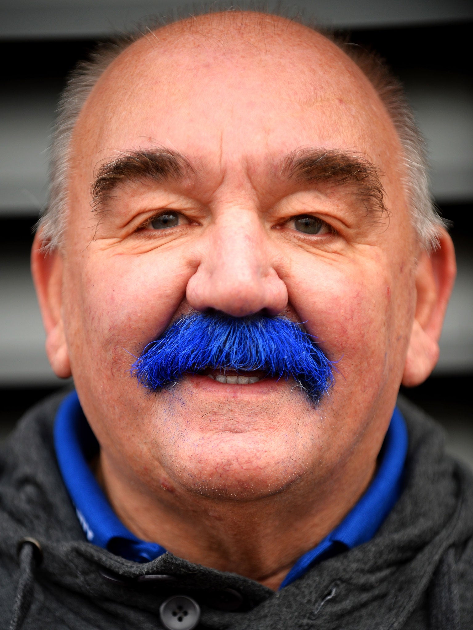 A Cardiff City fan shows of his 'blue moustache'