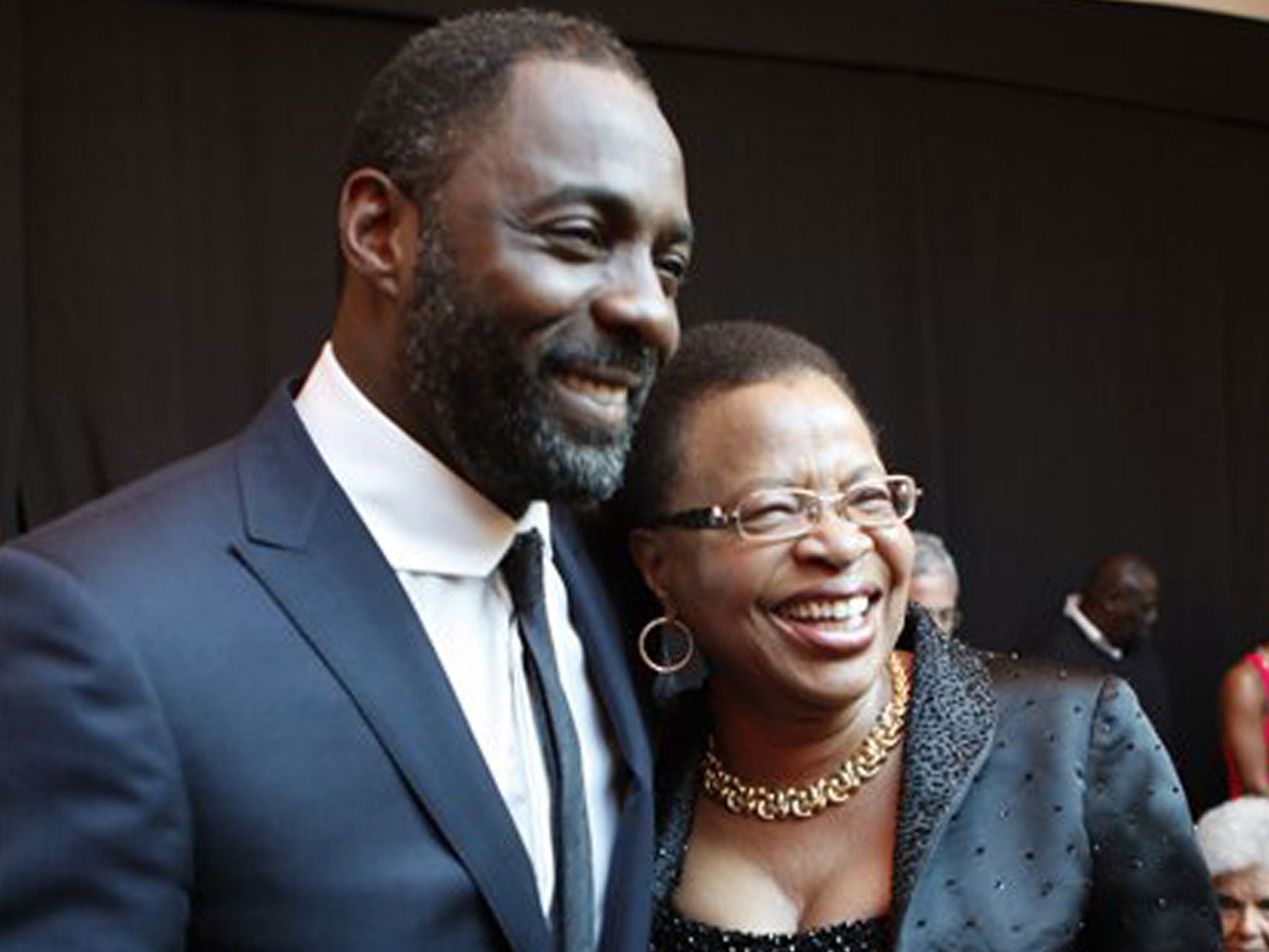Idris Elba with Graca Machel, the wife of former South African President Nelson Mandela, at the premiere of Mandela: Long Walk to Freedom in Johannesburg