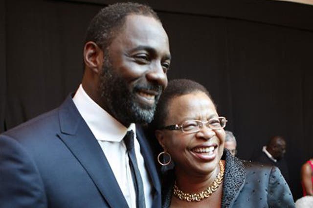 Idris Elba with Graca Machel, the wife of former South African President Nelson Mandela, at the premiere of Mandela: Long Walk to Freedom in Johannesburg