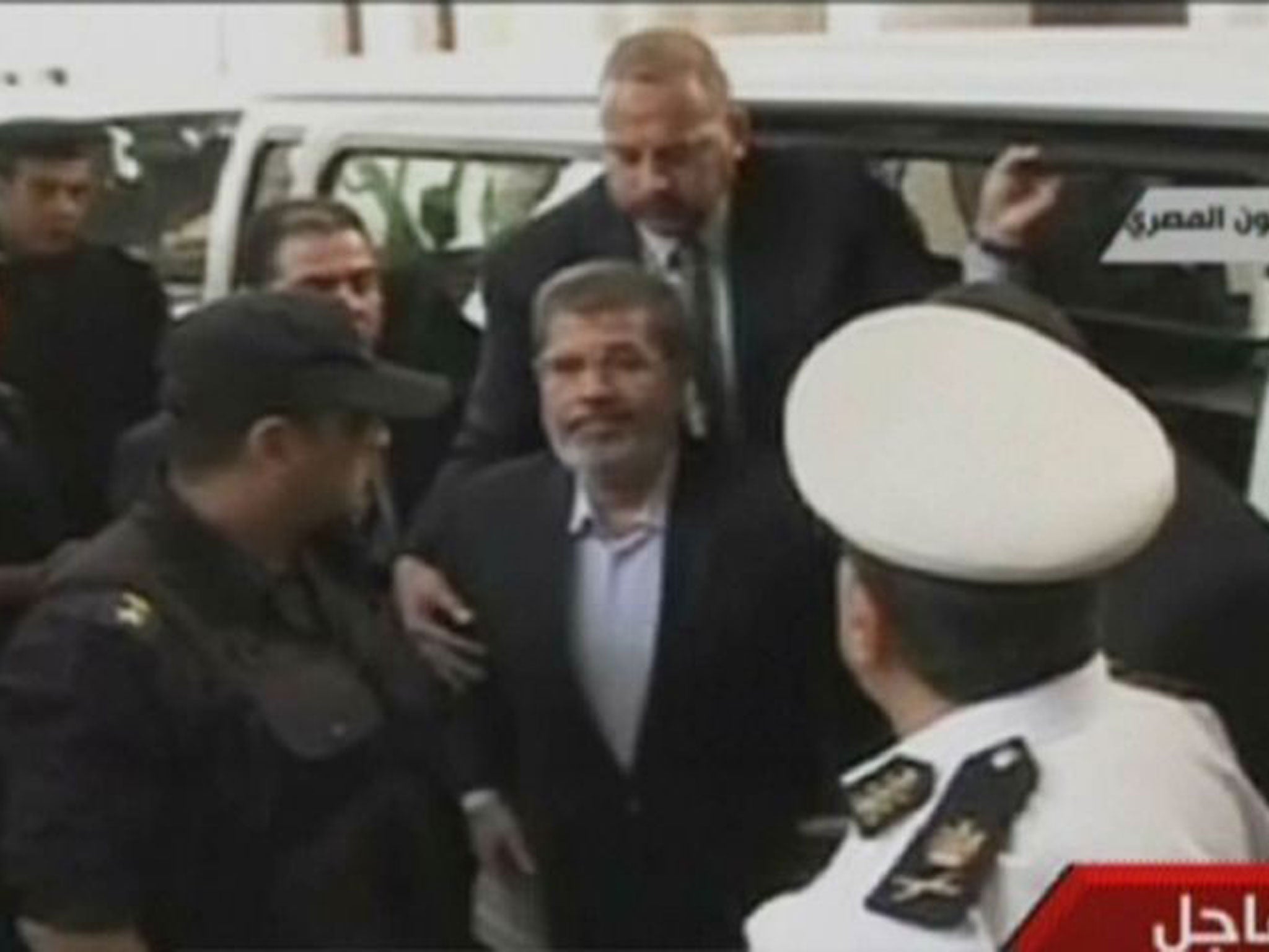 An image grab taken from Egyptian state TV shows ousted president Mohamed Morsi arriving in court
