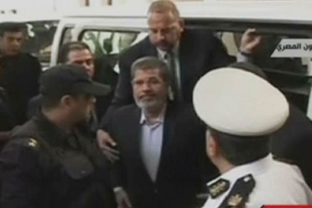 An image grab taken from Egyptian state TV shows ousted president Mohamed Morsi arriving in court