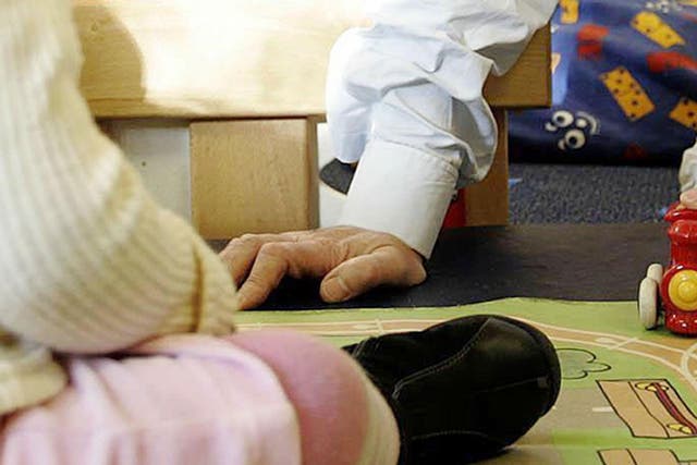 An adult playing with a child at a nursery - a senior Ofsted officer says children should be admitted to school from the age of two to eradicate the effects of poverty on their performance
