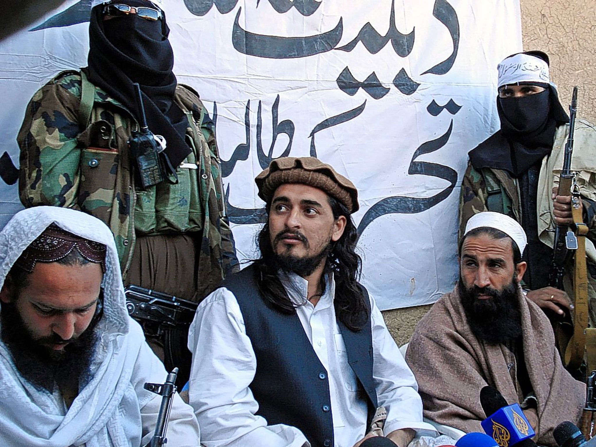 Mehsud, centre, meets journalists near the Afghanistan border