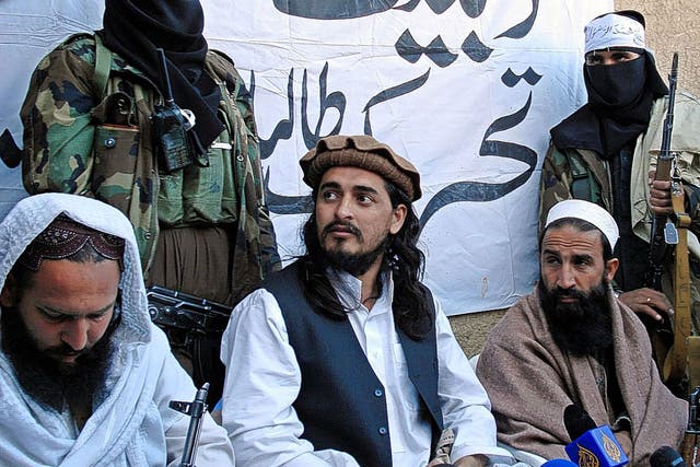 Mehsud, centre, meets journalists near the Afghanistan border