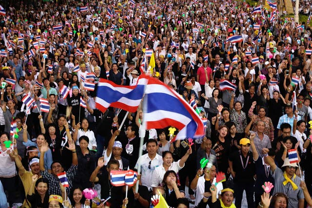 Anti-government protesters wave Thai flags during a rally against a controversial Amnesty bill that passed in Parliament. Protesters fear if the law is passed it could whitewash all crimes for which the former leader Thaksin Shinawatra was convicted