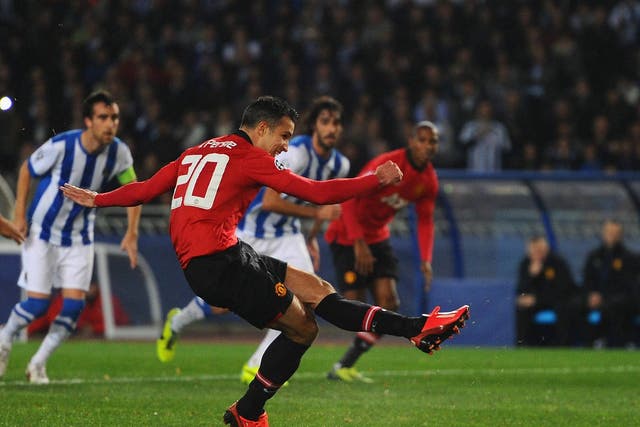 Ashley Young watches on as Robin van Persie hits the post from the penalty spot