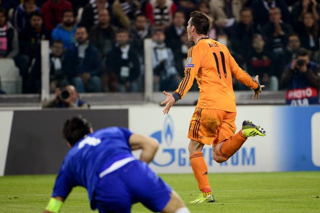 Real Madrid's Welsh striker Gareth Bale (R) celebrates after scoring a goal past Juventus' goalkeeper Gianluigi Buffon