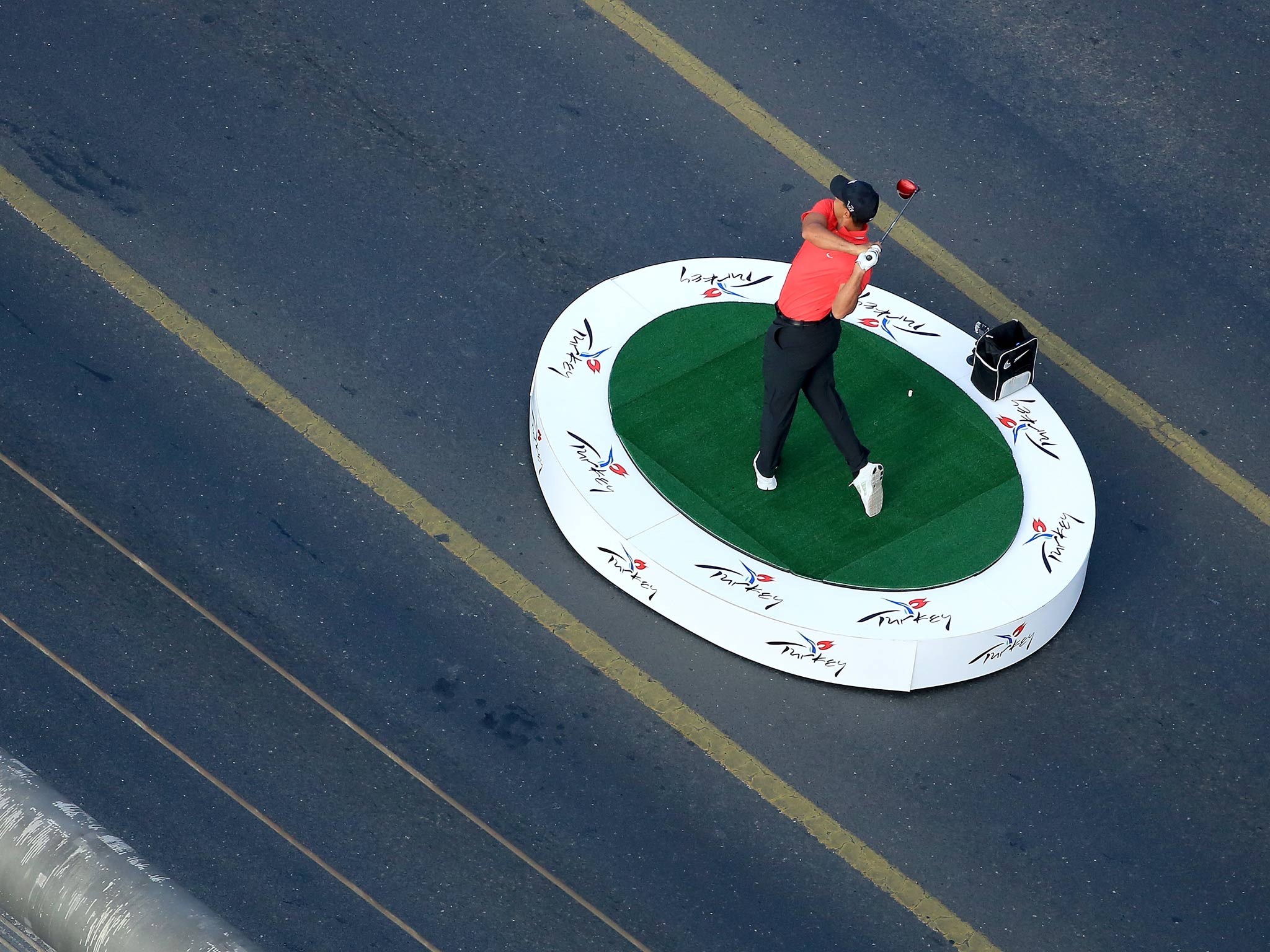 Tiger Woods makes history as he hits the first golf shots from East to West on Istanbul's iconic Bosphorus Bridge
