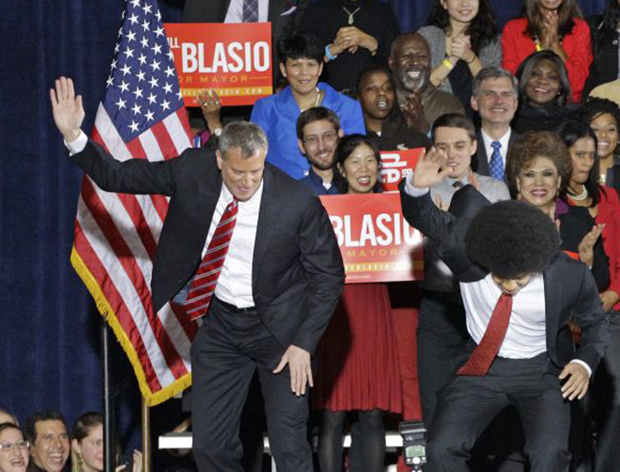 Supporters watch as Democratic mayor-elect Bill de Blasio and his son Dante perform the family's "smack down" dance on stage after de Blasio was elected mayorof New York City on November 5th